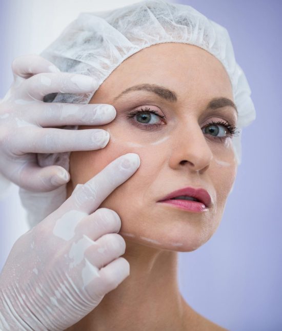 Doctor examining female patients face for cosmetic treatment